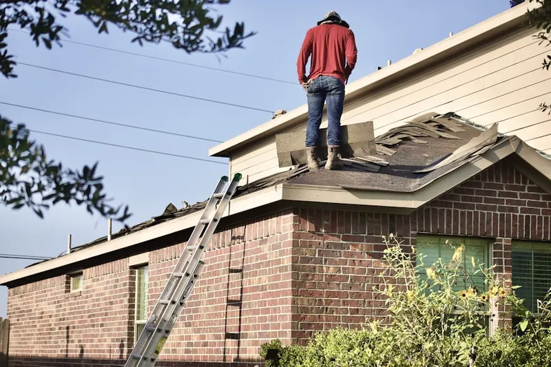 Professional roofer working on a residential roof in Downtown Watertown
